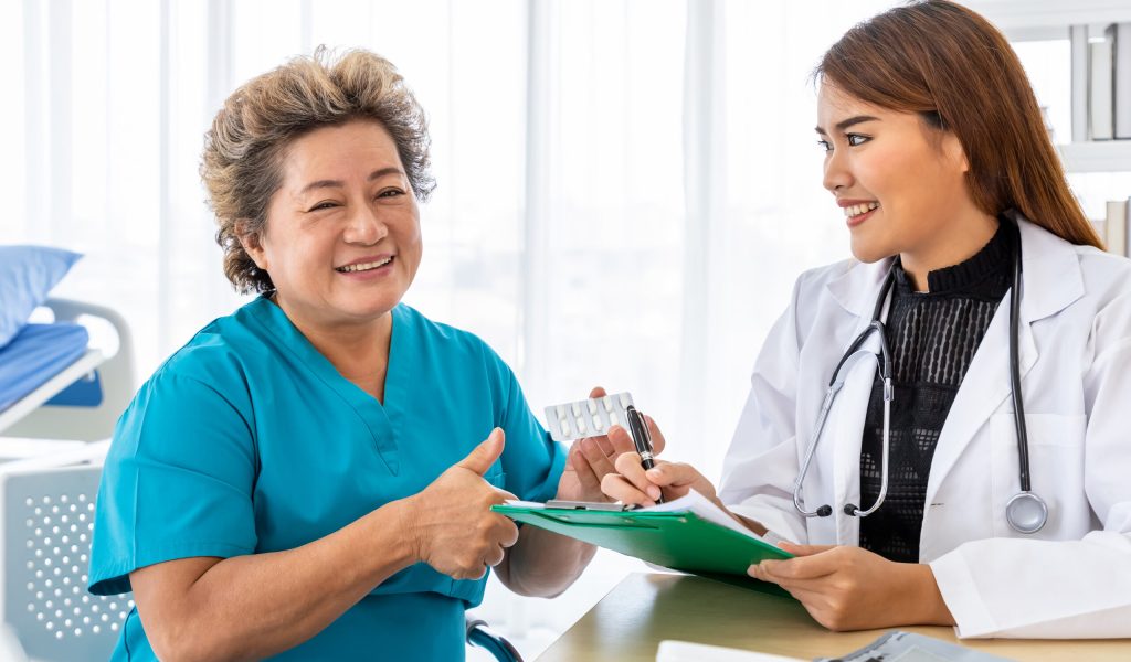 Asian medical doctor show give explain about medicine prescription to senior elderly patient